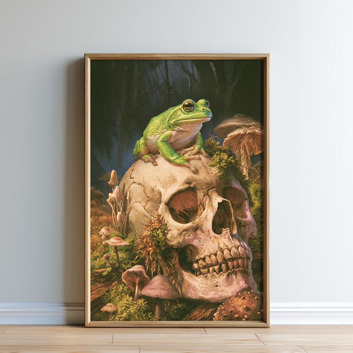A framed painting depicting a green frog perched on a skull surrounded by mushrooms and other natural elements.