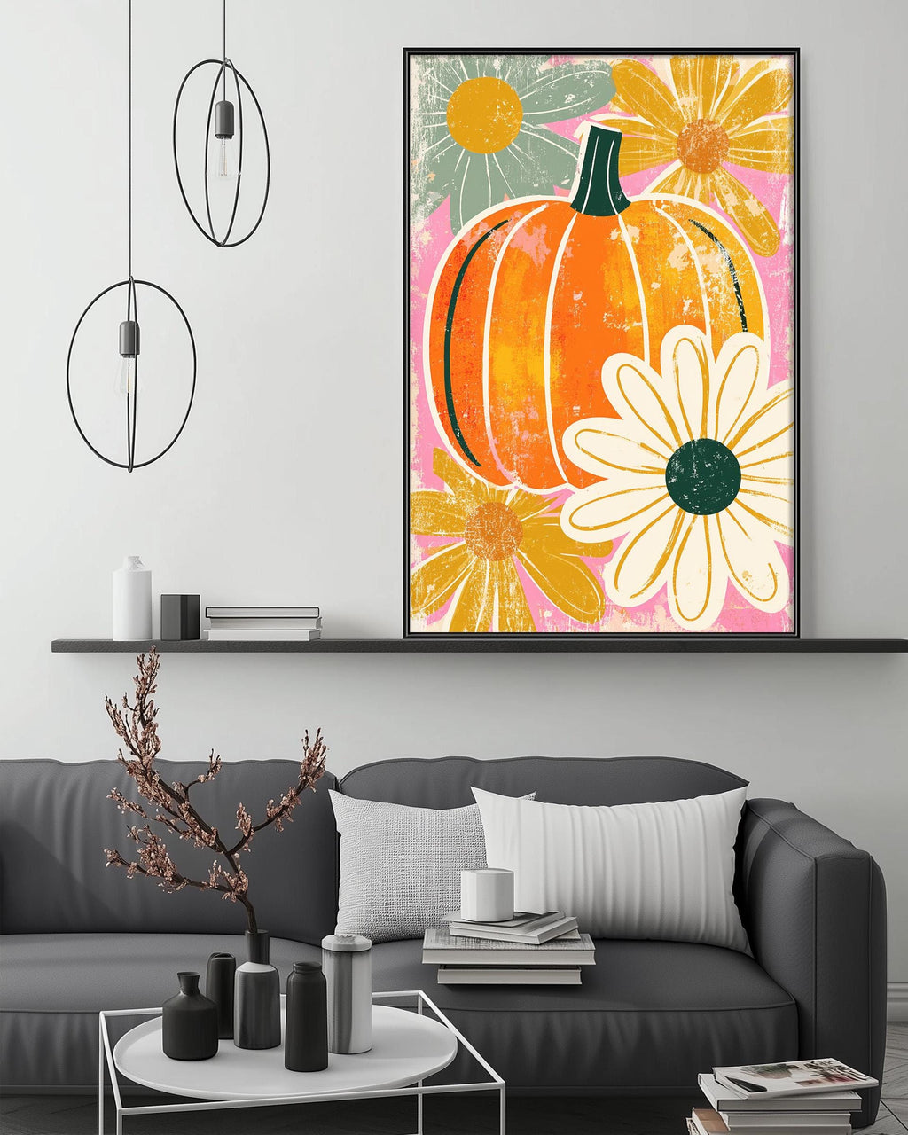 a modern living room with a gray sofa, a coffee table, and a large framed print of a pumpkin and flowers hanging on the wall above the sofa.
