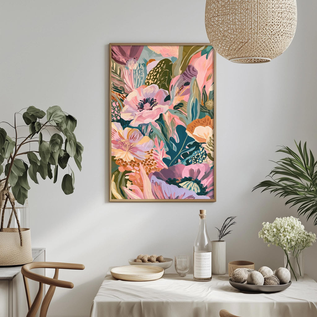 a vibrant and colorful floral painting hanging on a wall above a dining table, which is set with various decorative items such as a potted plant, a vase, and a bowl.