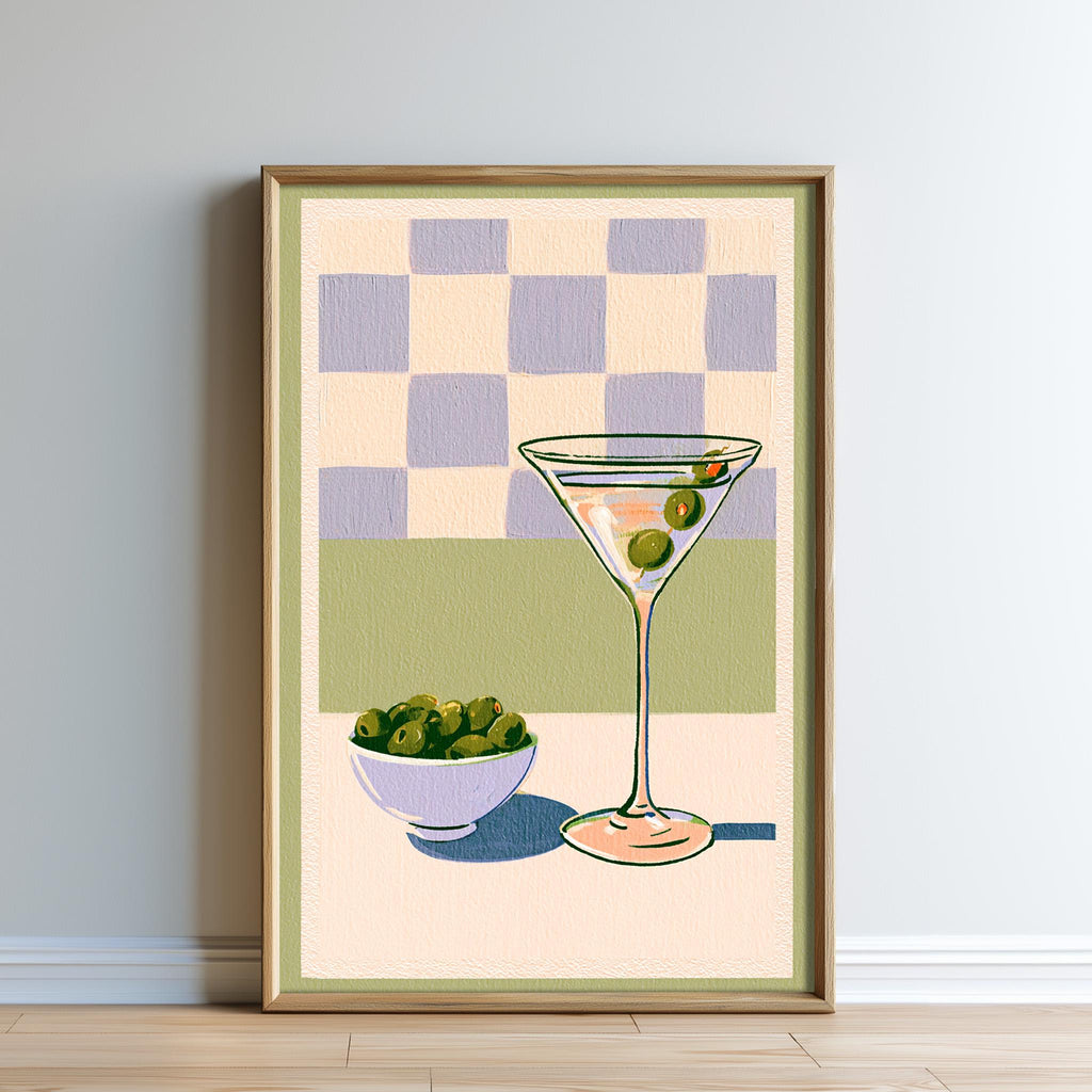 The image is a framed painting depicting a martini glass with olives and a bowl of olives on a table.
