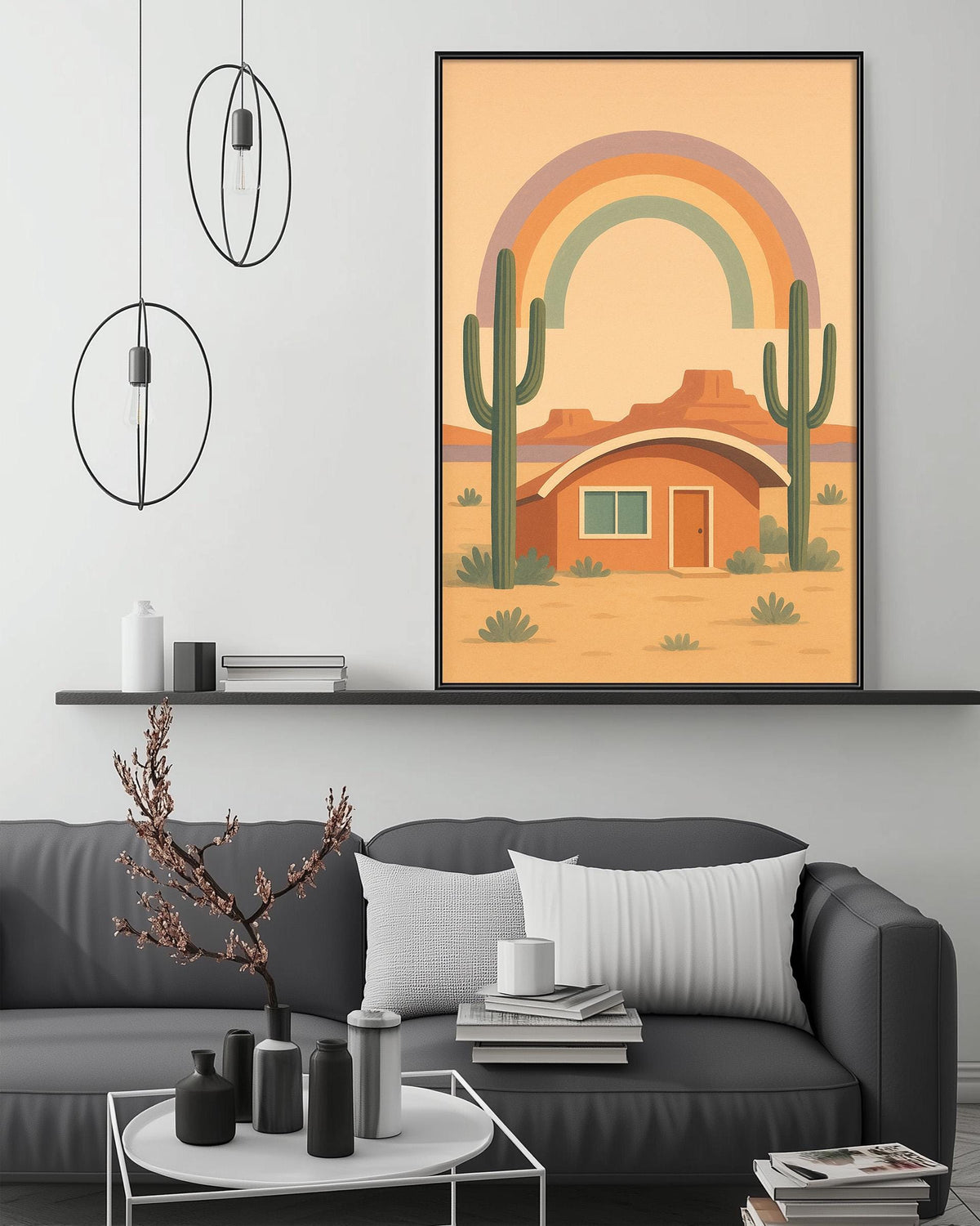 a modern living room with a gray sofa, a coffee table, and a framed illustration of a desert house with a rainbow in the background.