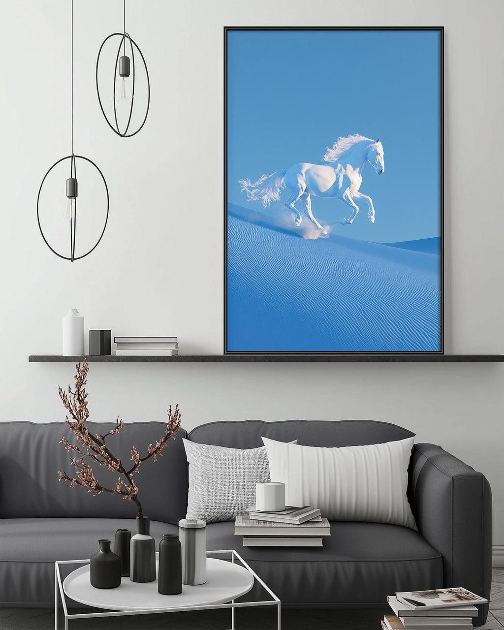 a large blue painting of a white horse running on a sandy beach, hanging on a wall above a gray couch with white pillows.