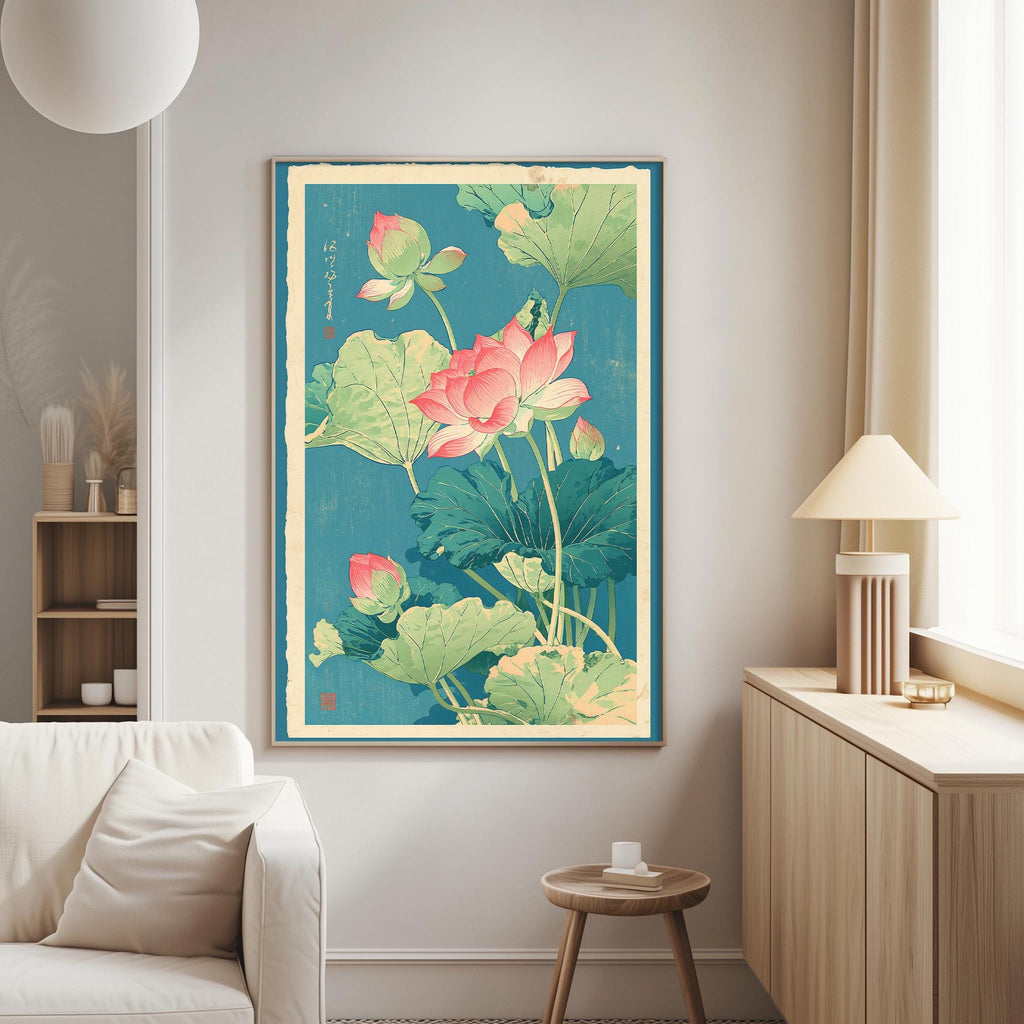 a large framed painting of a lotus flower and green leaves hanging on a wall in a living room.