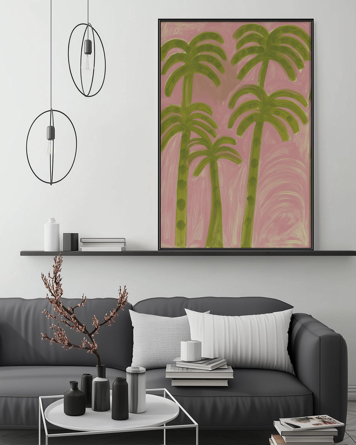 a modern living room with a gray sofa, a coffee table, and a large framed painting of palm trees on the wall.