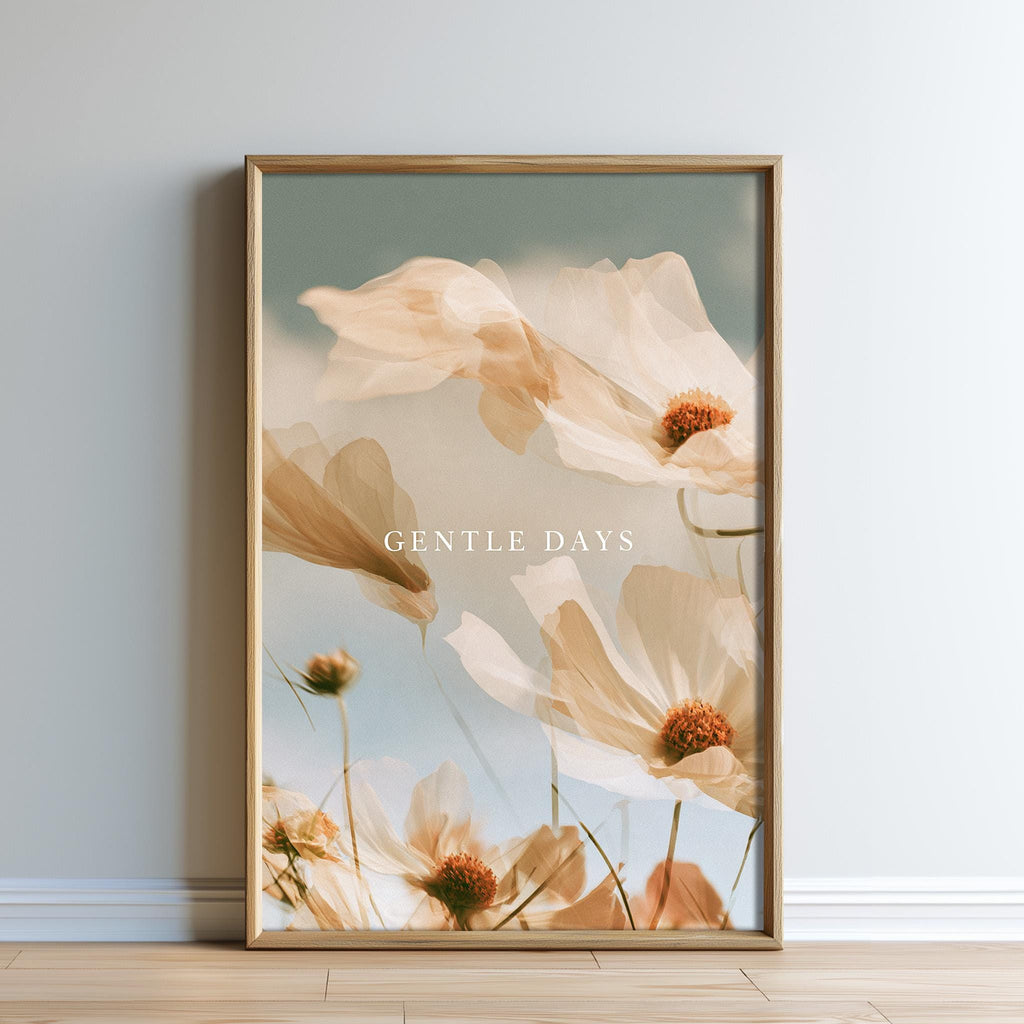 a framed photograph of delicate white flowers with orange centers, set against a soft, pale blue sky.