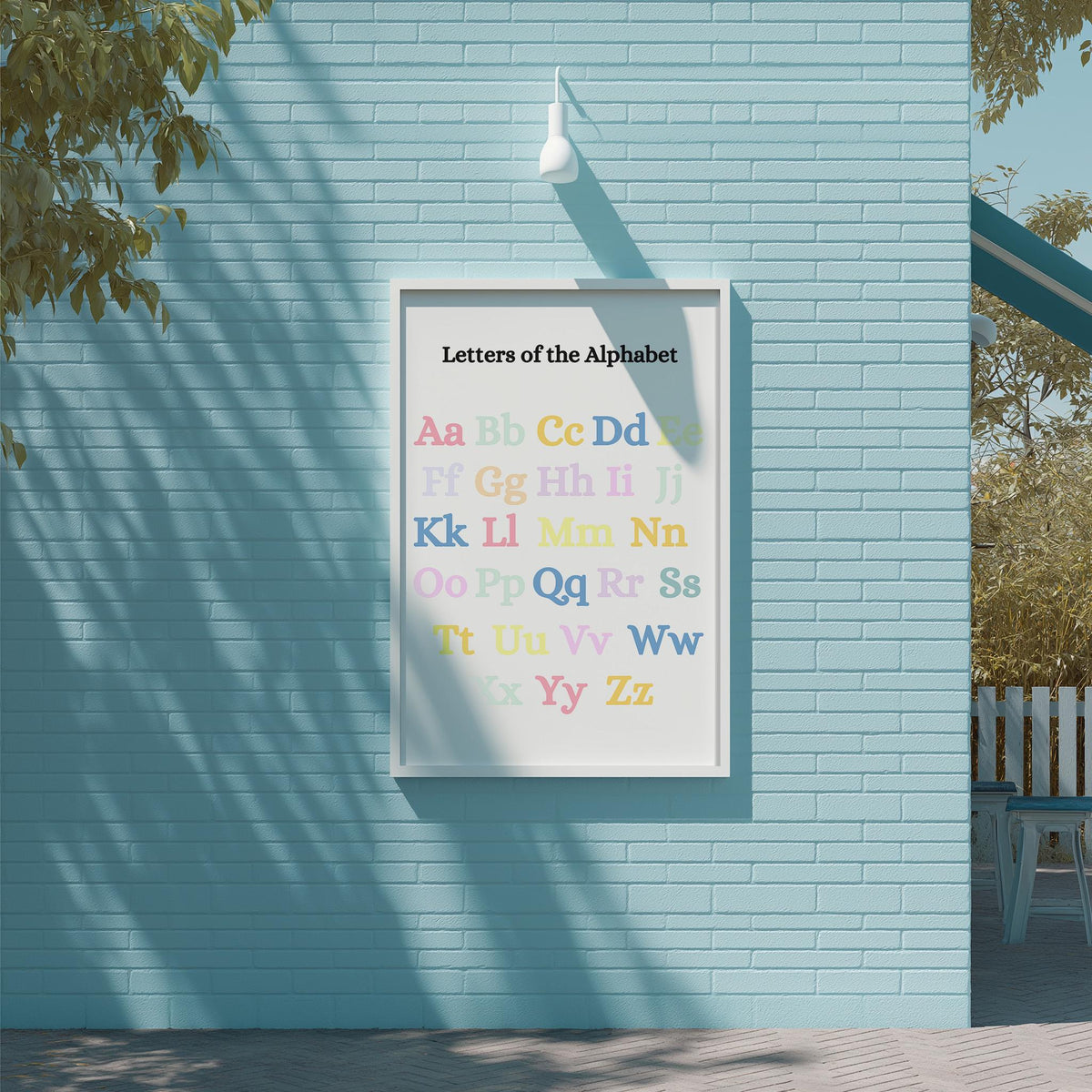 a blue brick wall with a framed alphabet poster hanging on it.