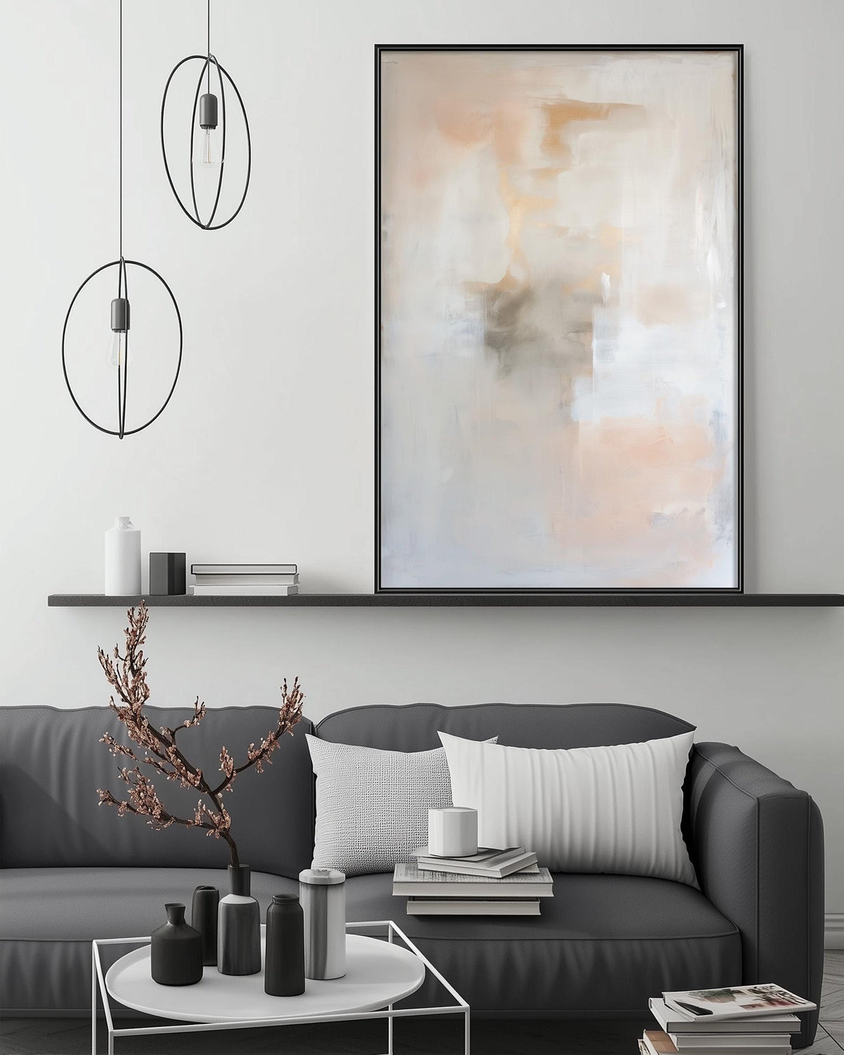 a modern living room with a gray sofa, a coffee table, and a large abstract painting hanging on the wall above the sofa.