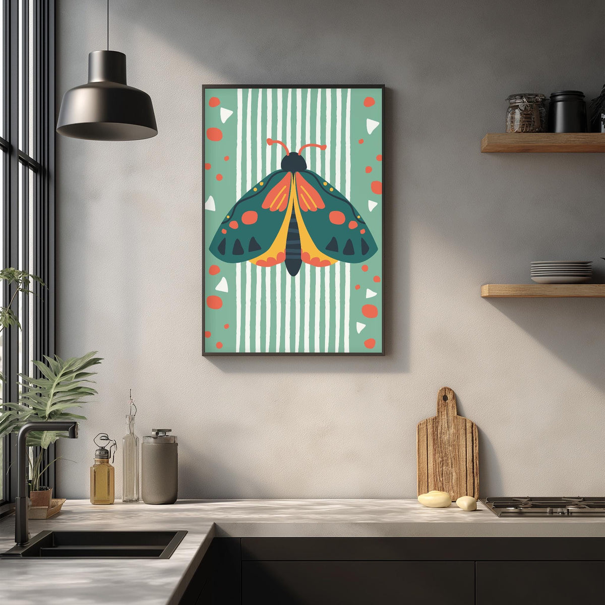a kitchen counter with a framed poster of a colorful butterfly hanging on the wall above it. The poster has a vibrant design with a green background, white stripes, and orange and yellow accents. The kitchen counter also has various items such as a cutting board, a bottle, and a plant.
