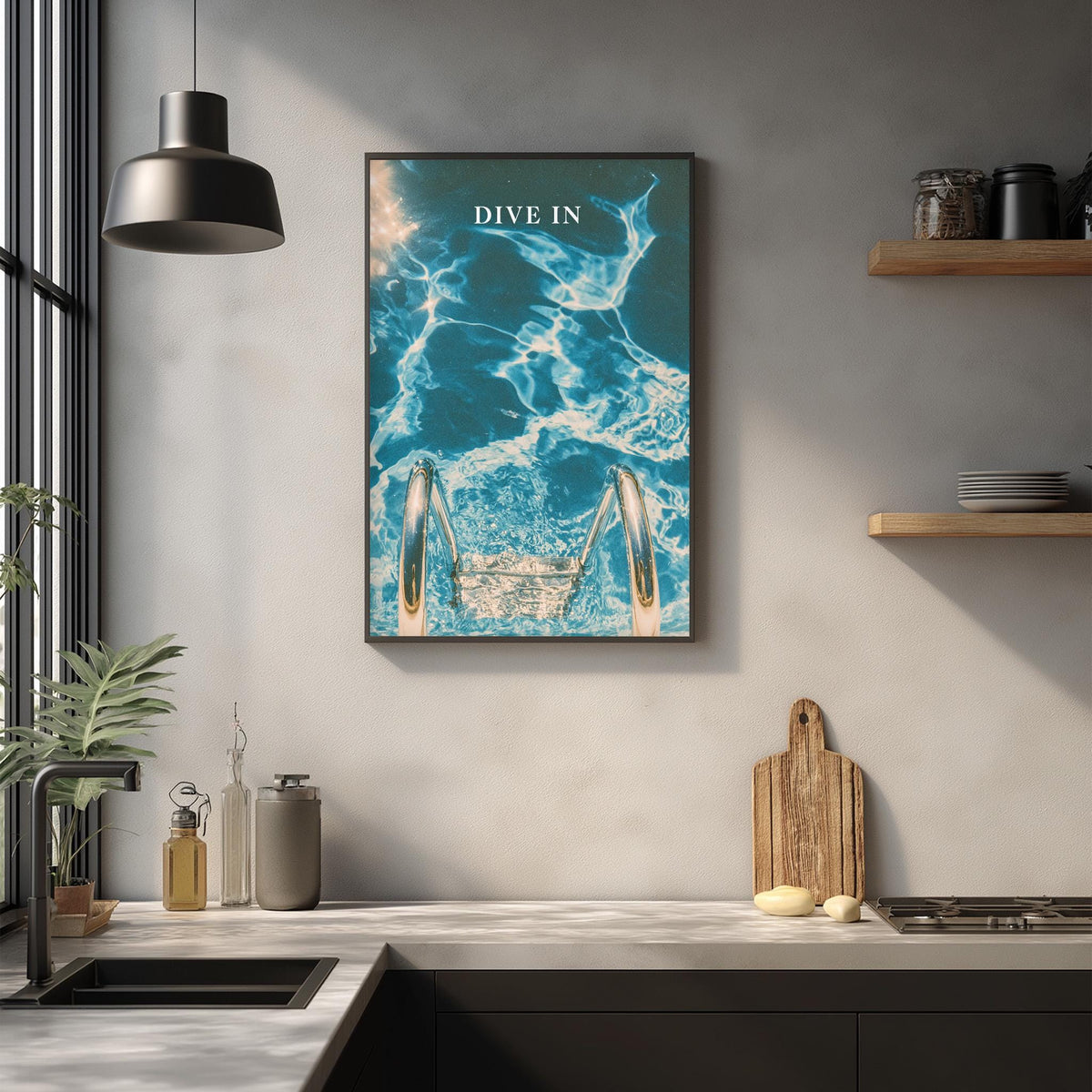 a kitchen counter with various items such as a cutting board, a bottle, and a plant. Above the counter, there is a framed poster with a blue and white ocean scene, and the word "DIVE" is written on it.