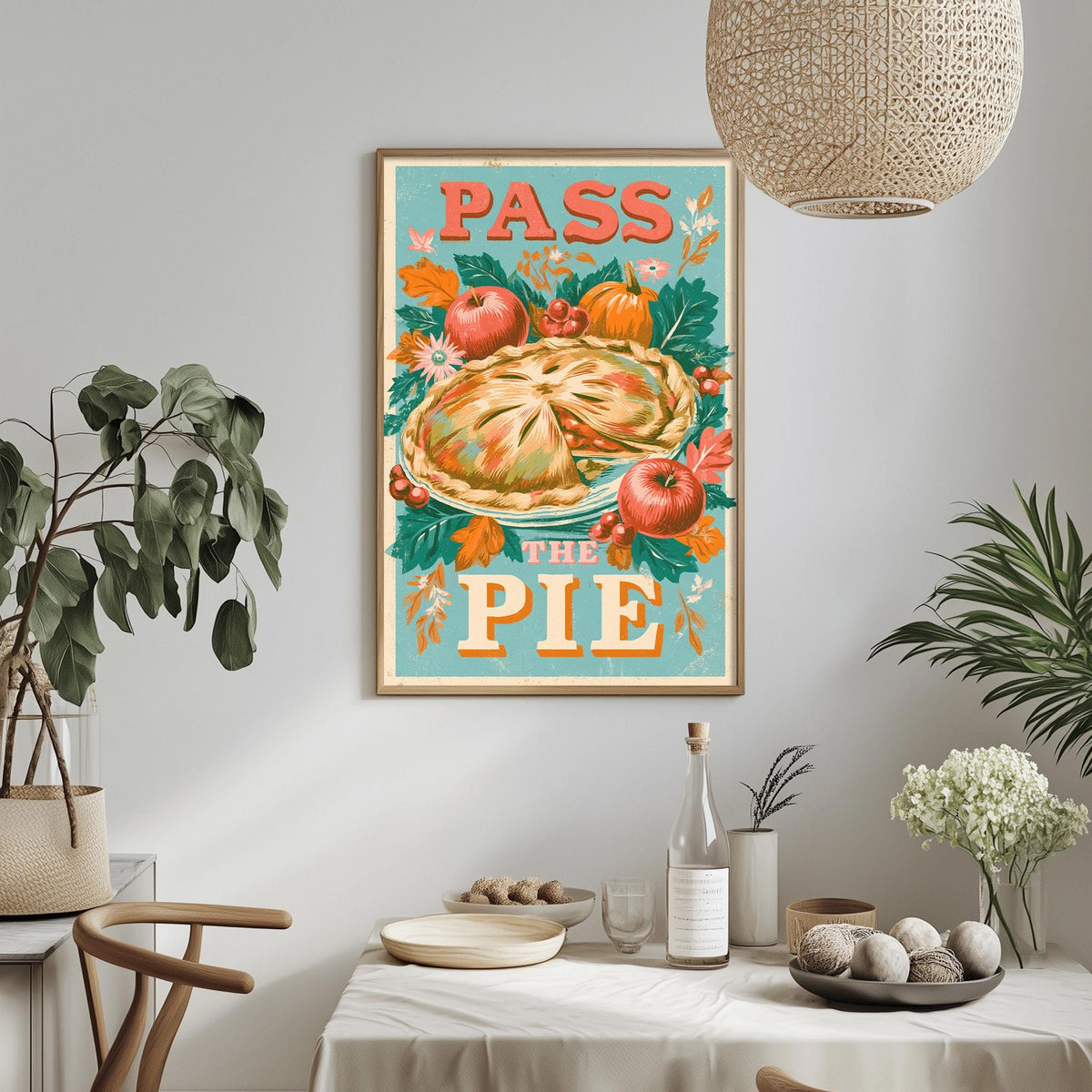 a framed poster with the text "Pass the Pie" hanging on a wall above a dining table with various items on it.