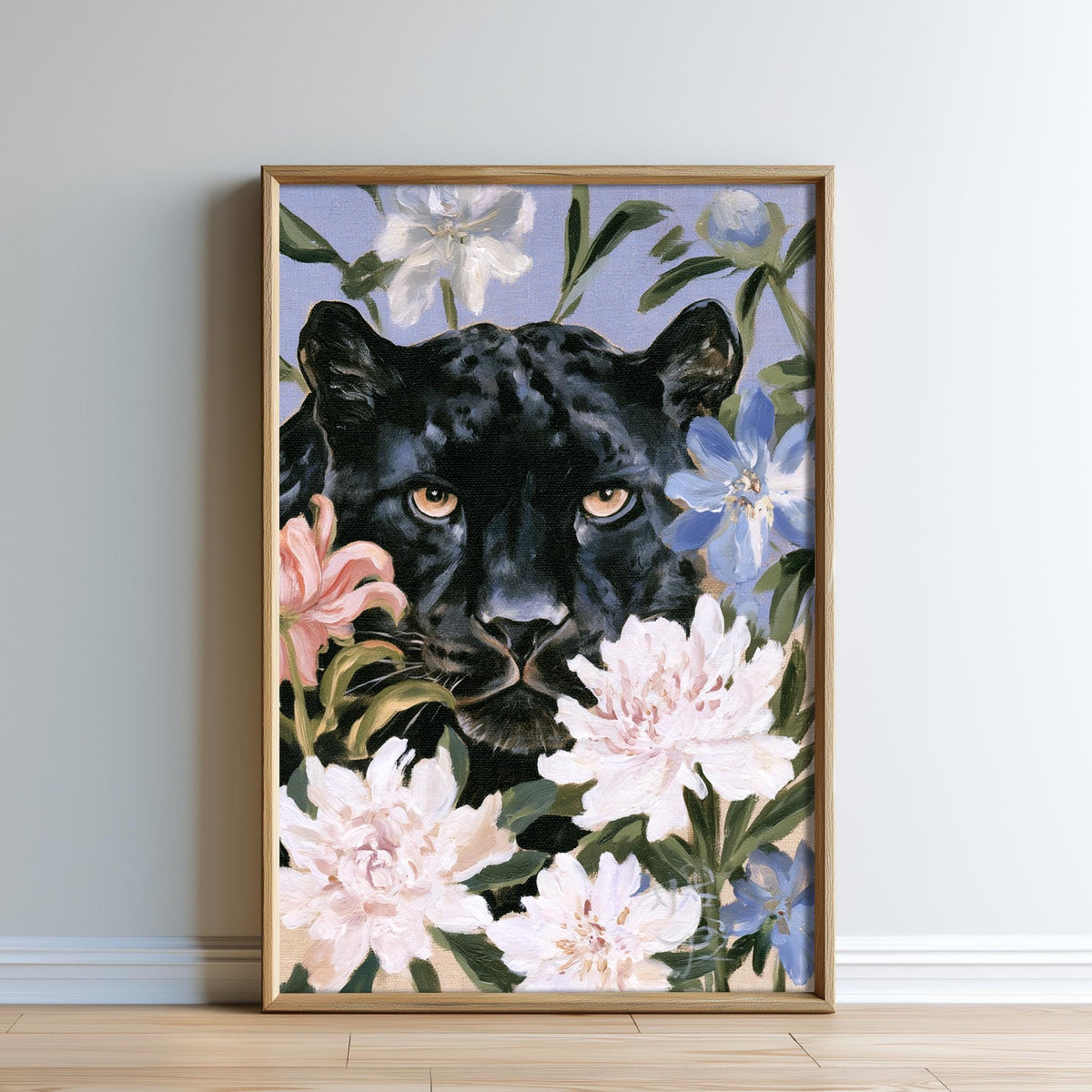A framed painting depicting a black panther surrounded by colorful flowers, including pink and white blooms, against a blue background.