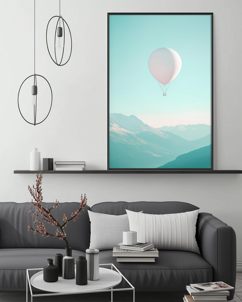 a modern living room with a gray sofa, a coffee table, and a large framed picture of a hot air balloon floating in the sky above the sofa.