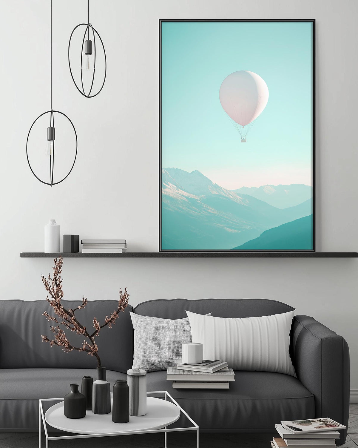 a modern living room with a gray sofa, a coffee table, and a large framed picture of a hot air balloon floating in the sky above the sofa.