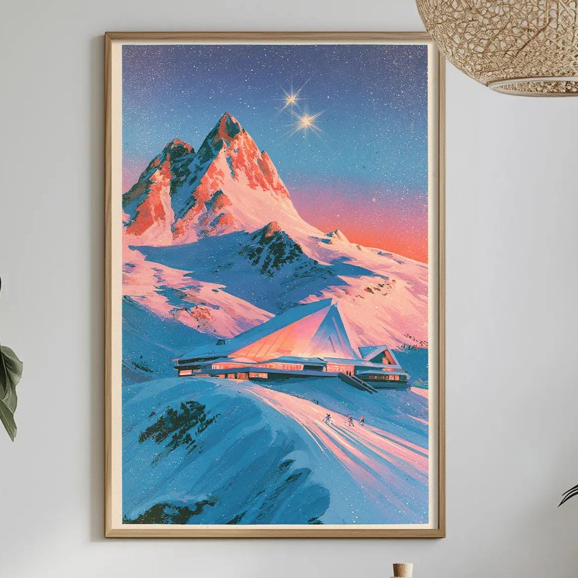 a framed painting of a snowy mountain landscape with a starry sky, hanging on a wall above a dining table with various decorative items and plants.