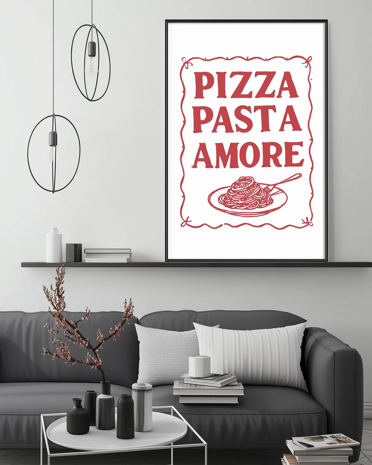 a living room with a gray couch, a coffee table, and a framed poster with the text "PIZZA PASTA AMORE" above a picture of spaghetti and meatballs.