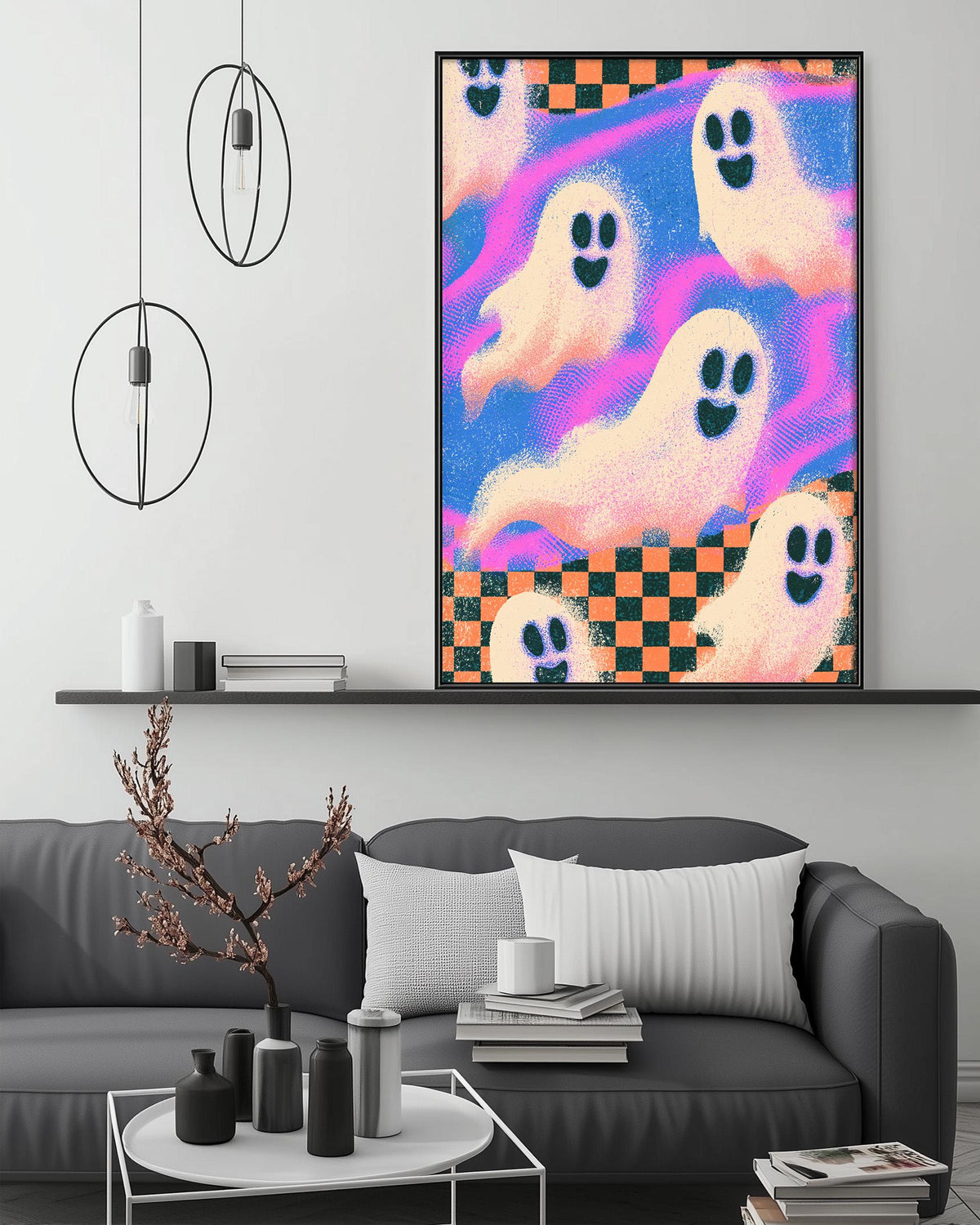 a living room with a gray couch, a coffee table, and a large framed poster of ghostly figures on the wall.