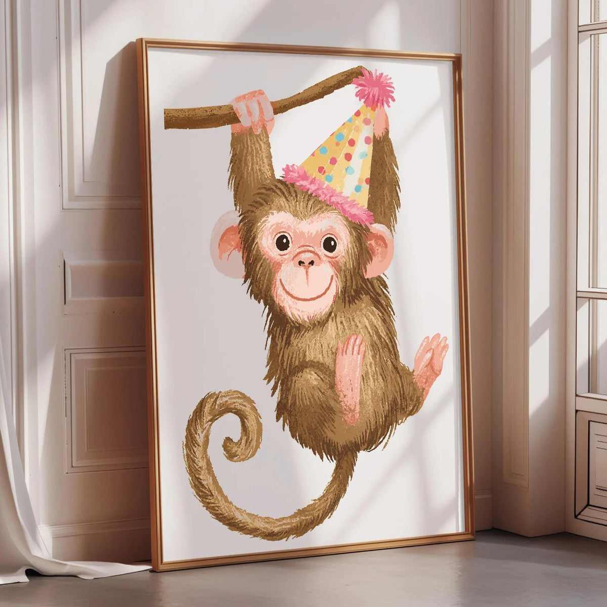 A framed illustration of a monkey wearing a party hat, hanging from a branch.