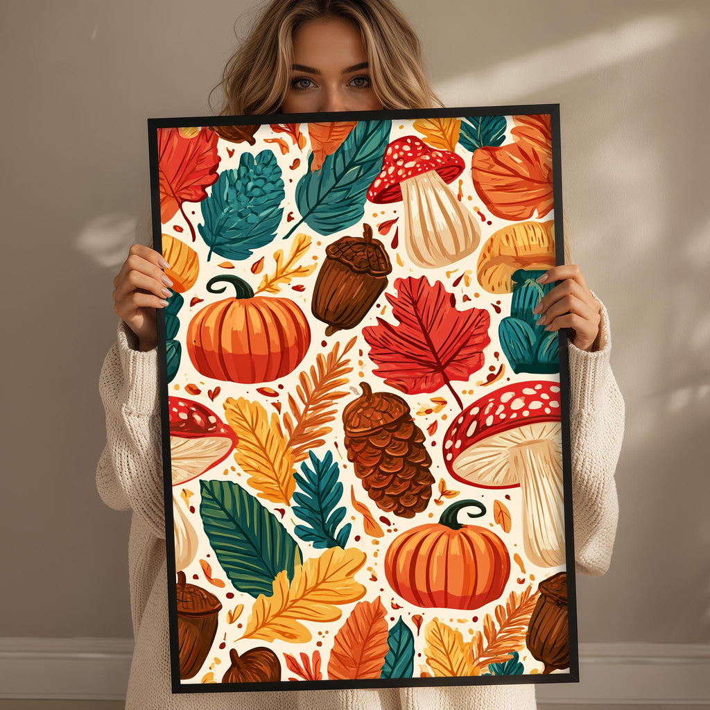 A woman is holding up a framed print with a vibrant autumn-themed design featuring various fall fruits and vegetables such as pumpkins, acorns, mushrooms, and leaves.