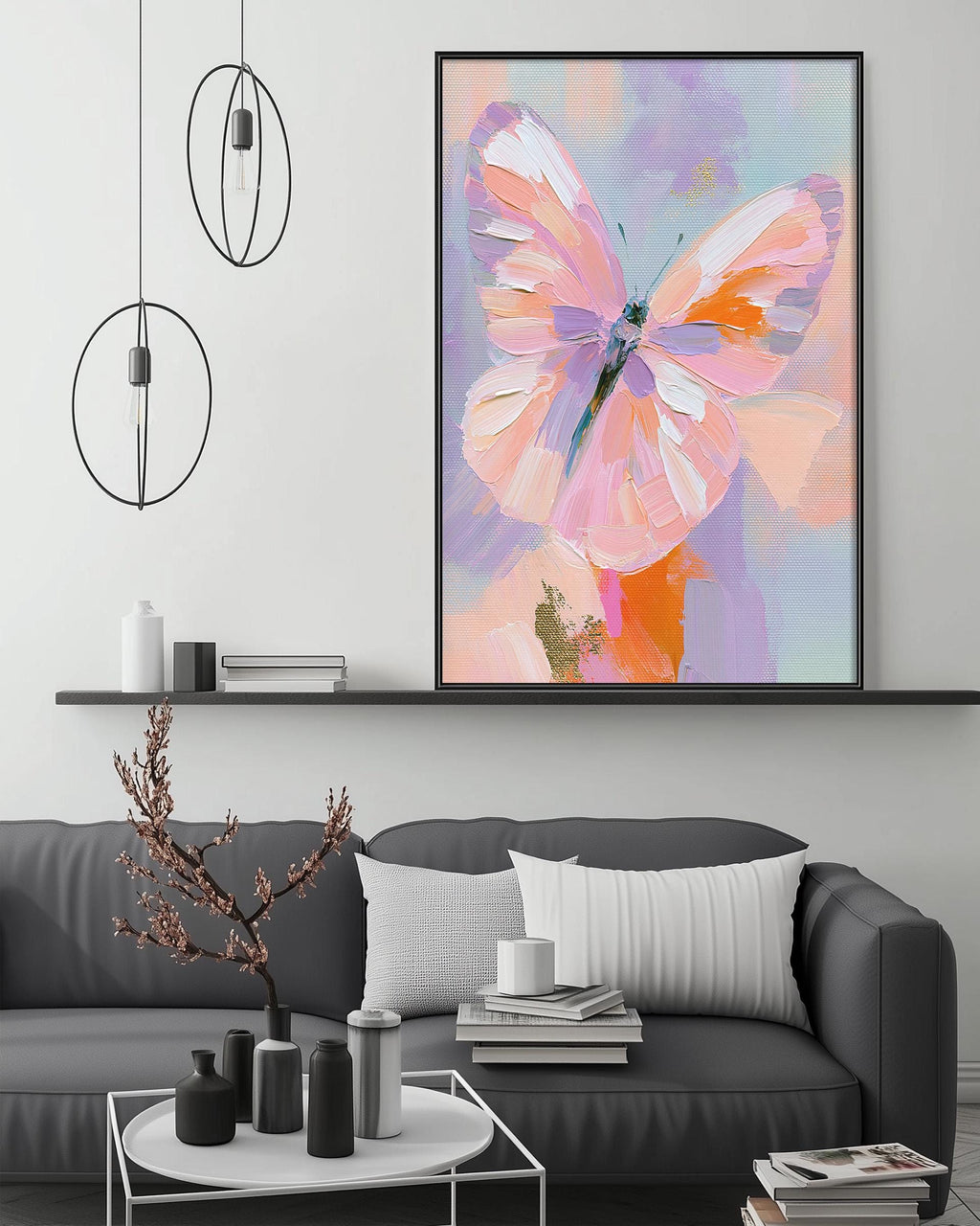a large, colorful painting of a butterfly hanging on a wall above a gray couch in a living room setting.