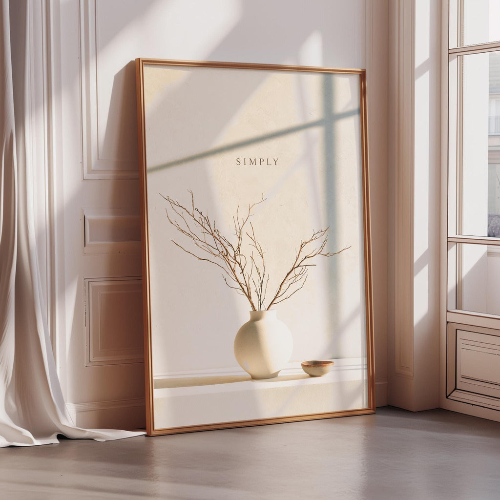 A large framed print with a minimalist design of a vase with branches and a bowl on a shelf, placed in a corner of a room with a window.