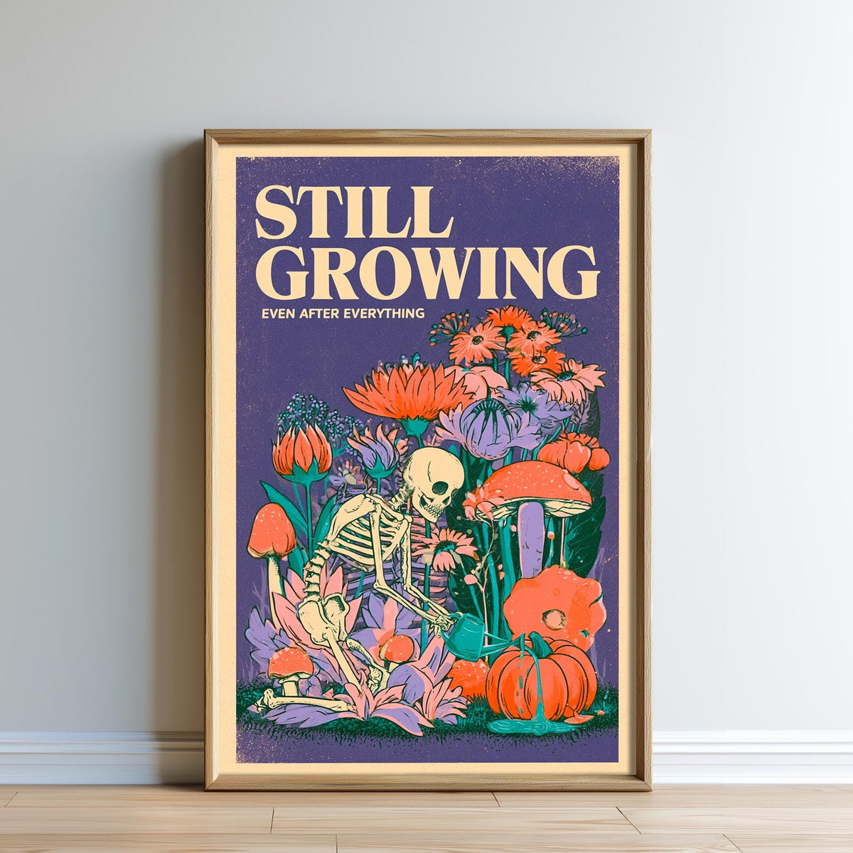 The image is a framed poster with a skeleton and various flowers and mushrooms. The poster has a purple background and the text "STILL GROWING" and "EVER AFTER EVERYTHING" written on it.