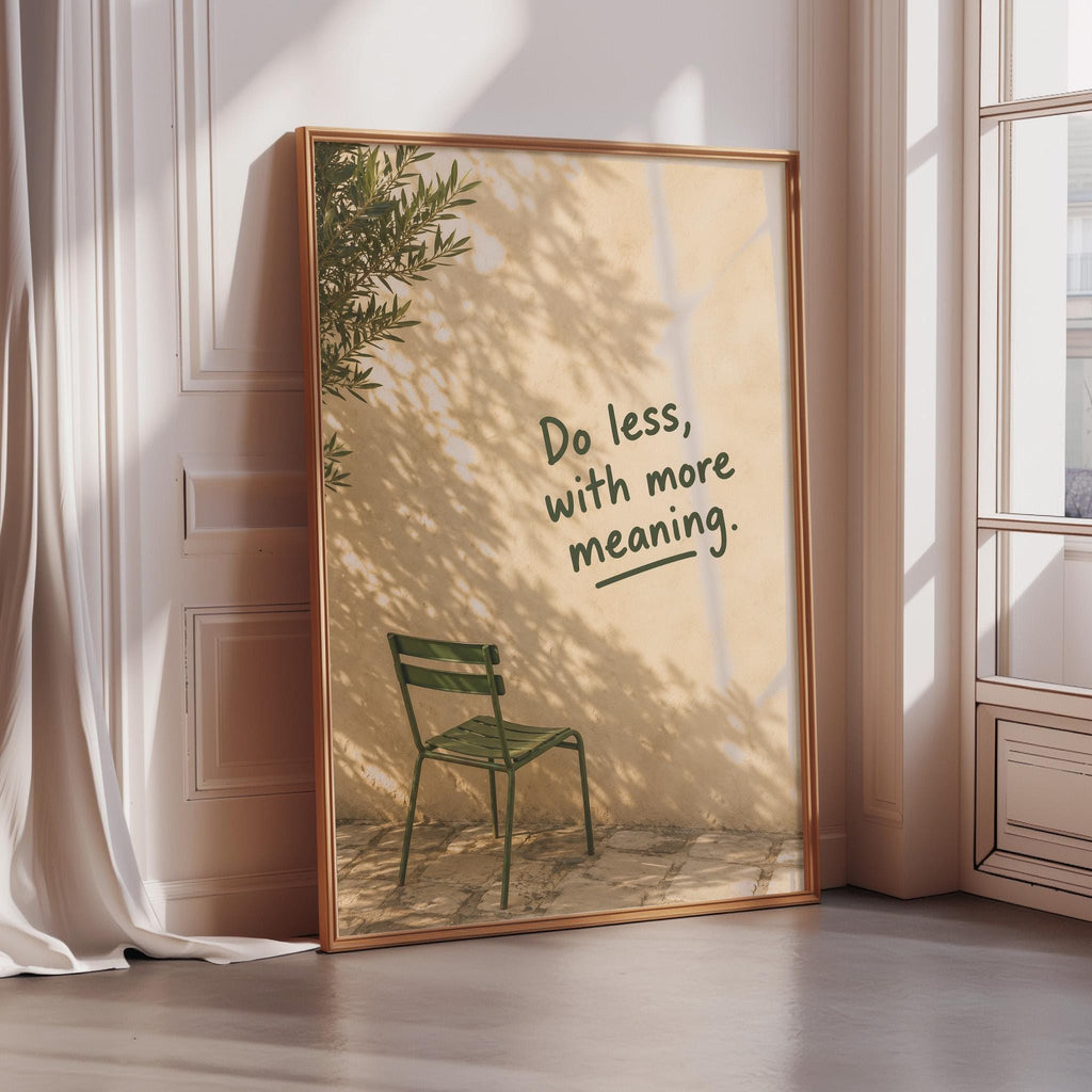 a framed poster with a green chair and a tree in the background, along with the text "Do less, with more meaning."