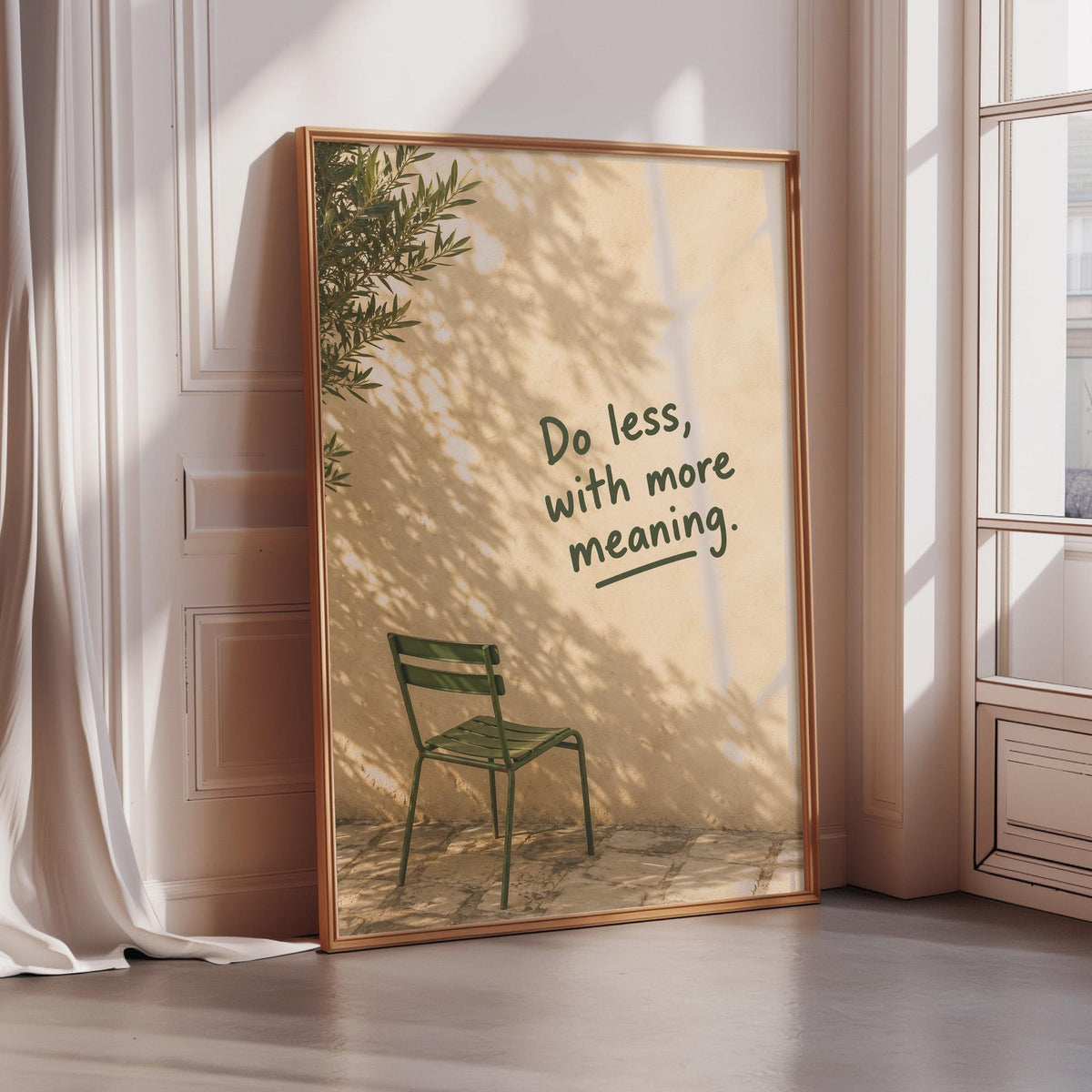 a framed poster with a green chair and a tree in the background, along with the text "Do less, with more meaning."
