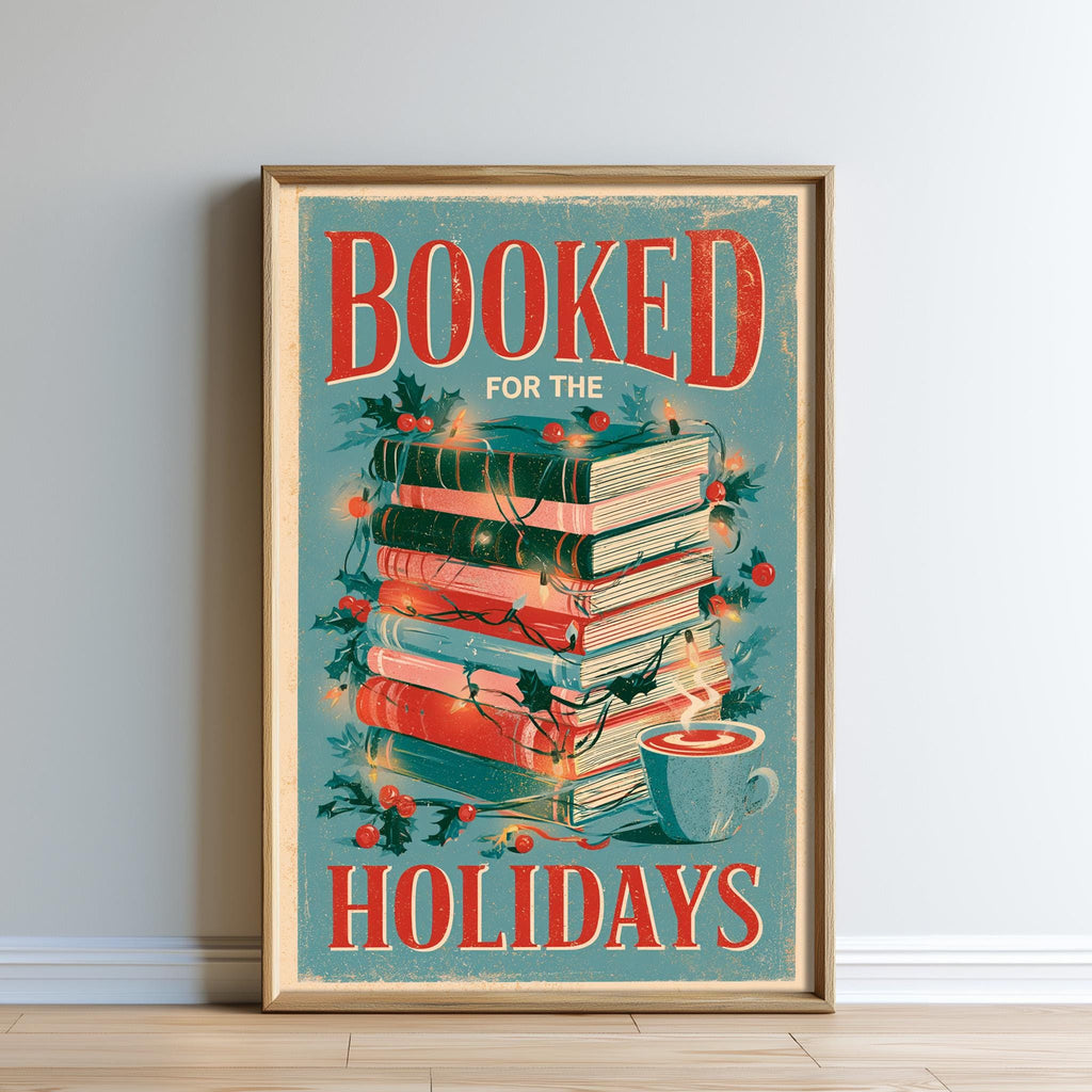 The image is a framed poster with a vintage-style design, featuring a stack of books and holiday decorations such as holly leaves and berries. The text on the poster reads "BOOKED FOR THE HOLIDAYS".