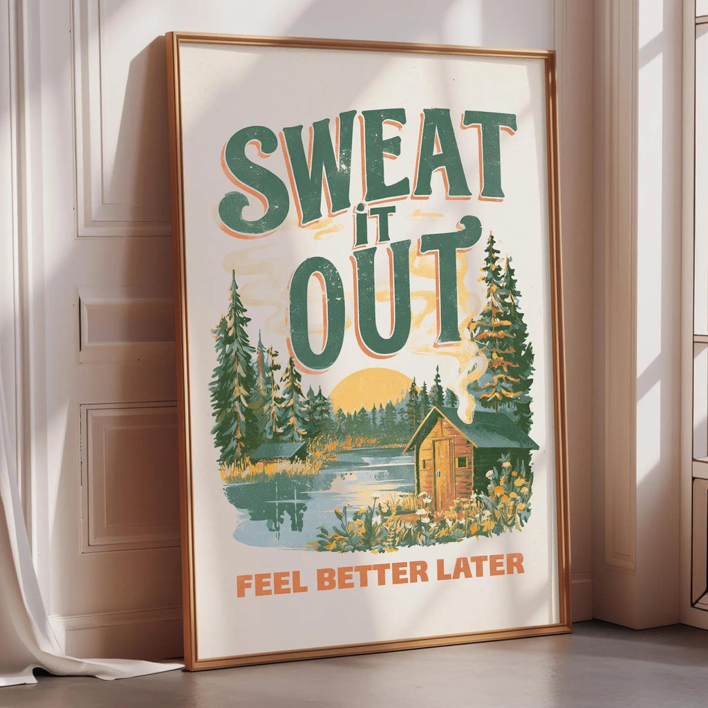 a framed poster with a scenic landscape and the text "SWEAT IT OUT" prominently displayed.