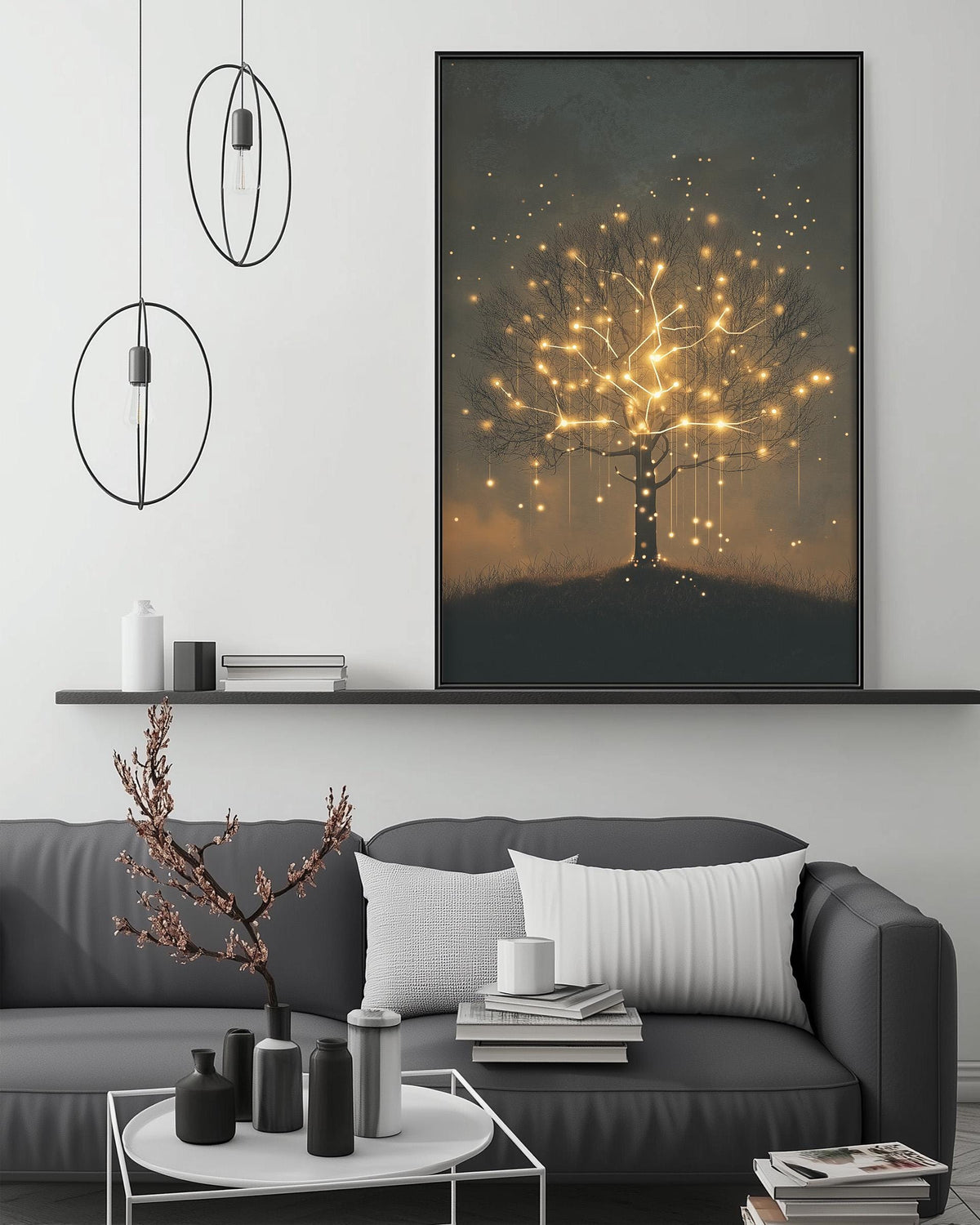 a modern living room with a gray sofa, a coffee table, and a large framed artwork depicting a glowing tree with lights. The room has a minimalist and stylish design, with a black pendant light hanging above the sofa and a white shelf below the artwork.