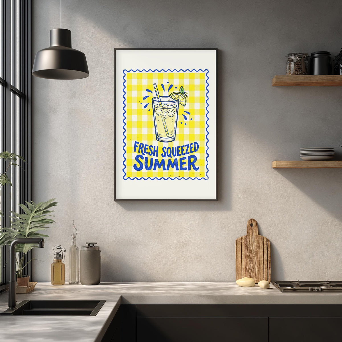 a kitchen counter with a framed poster of a lemonade glass and the text "FRESH SQUEEZED SUMMER" above it.