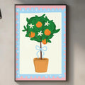 a kitchen counter with a potted plant, a cutting board, and various kitchen items such as a bottle and a vase. Above the counter, there is a framed illustration of a tree with orange flowers and green leaves.