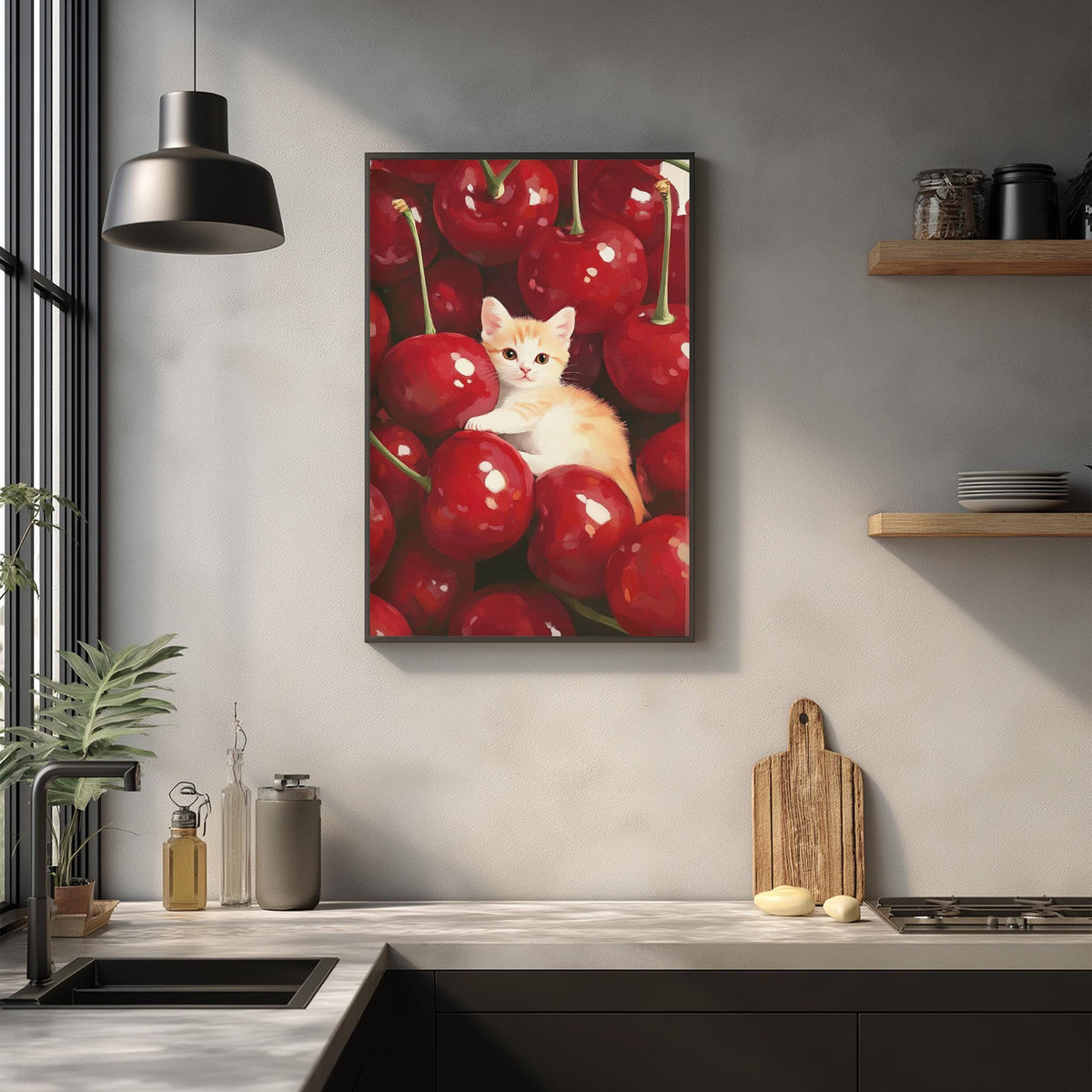 A framed painting of a cat sitting among a bunch of red cherries hangs on a wall in a kitchen.