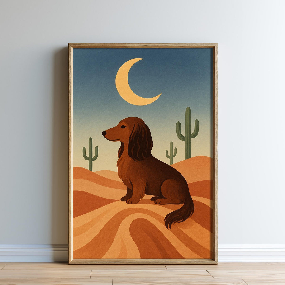 A framed illustration depicting a dachshund dog sitting on a sandy desert landscape, with cacti and a crescent moon in the background.
