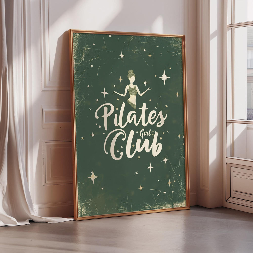 a framed poster with the text "Pilates Girl Club" and a stylized illustration of a woman doing Pilates exercises.