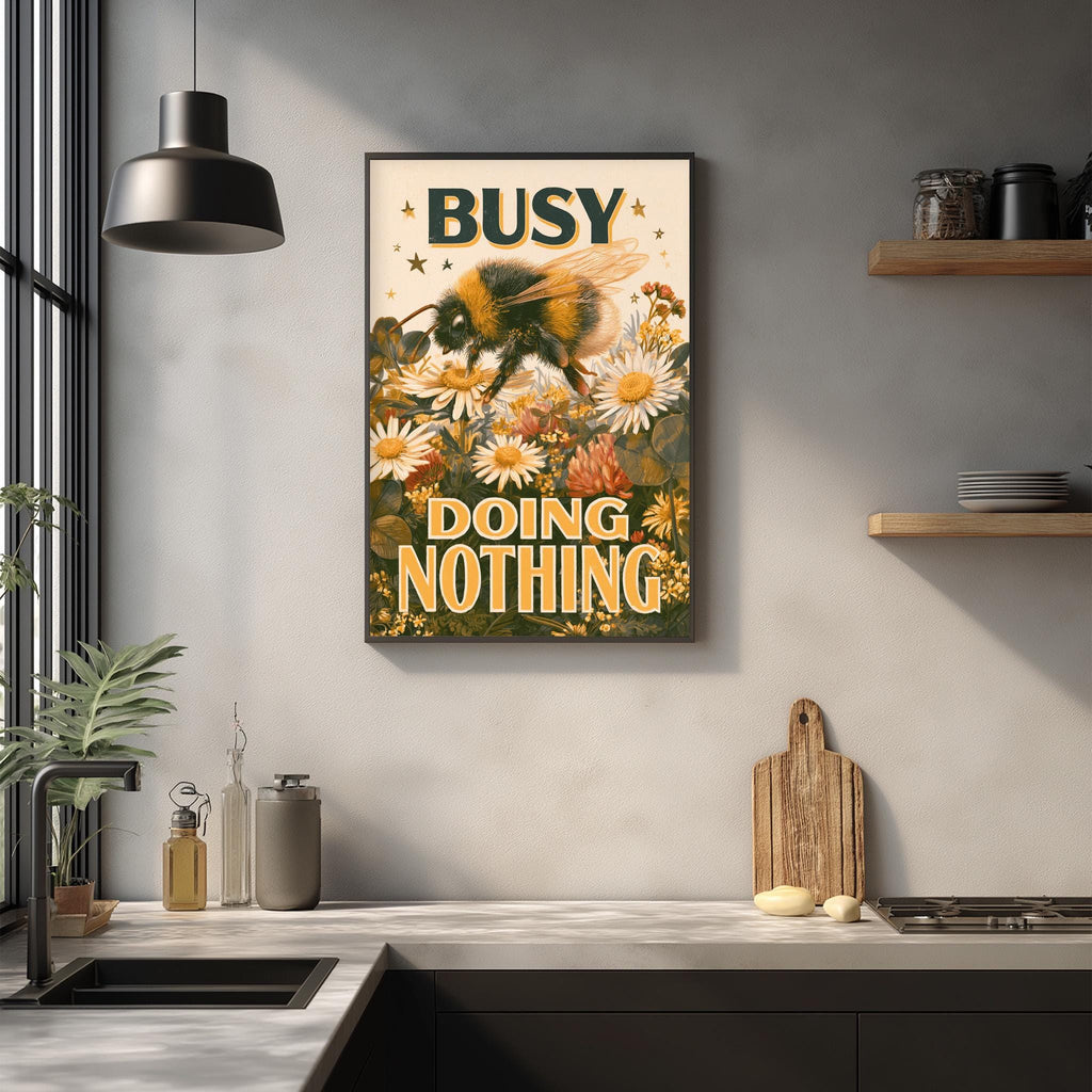 a framed poster with a bee and flowers hanging on a wall above a kitchen counter.