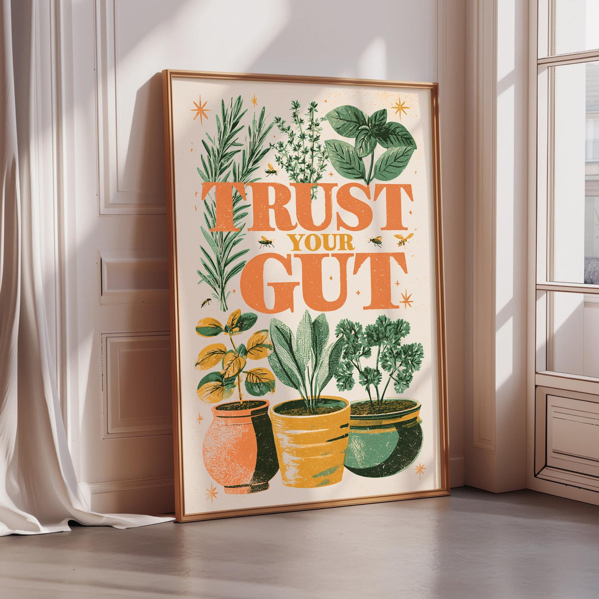 a framed poster with a vibrant illustration of potted plants and the text "Trust Your Gut" displayed on it.