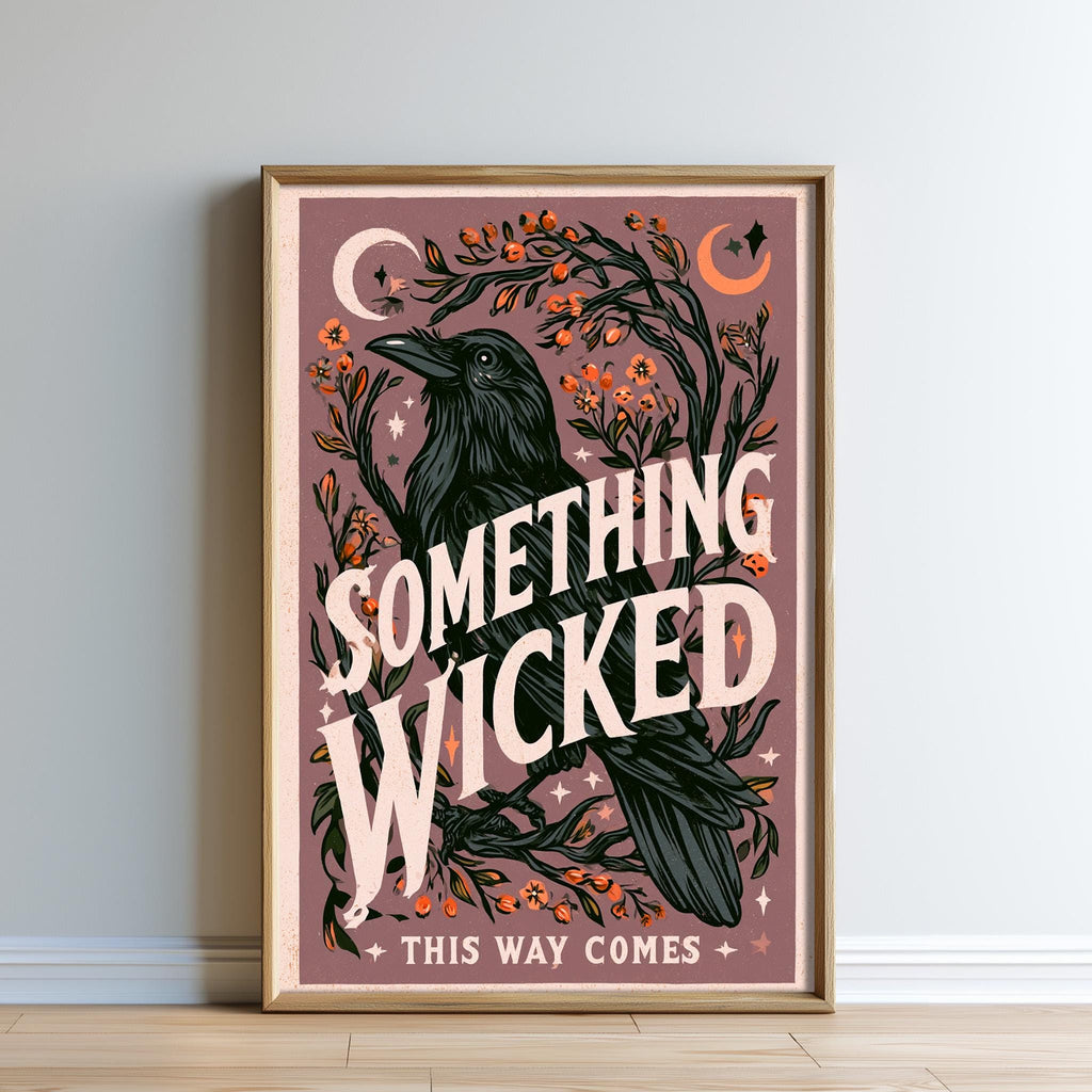 The image is a framed poster with a black crow and various floral and celestial elements, including a crescent moon and stars. The text on the poster reads "Something Wicked This Way Comes", and the phrase "THIS WAY COMES" is also present.