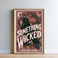 The image is a framed poster with a black crow and various floral and celestial elements, including a crescent moon and stars. The text on the poster reads "Something Wicked This Way Comes", and the phrase "THIS WAY COMES" is also present.