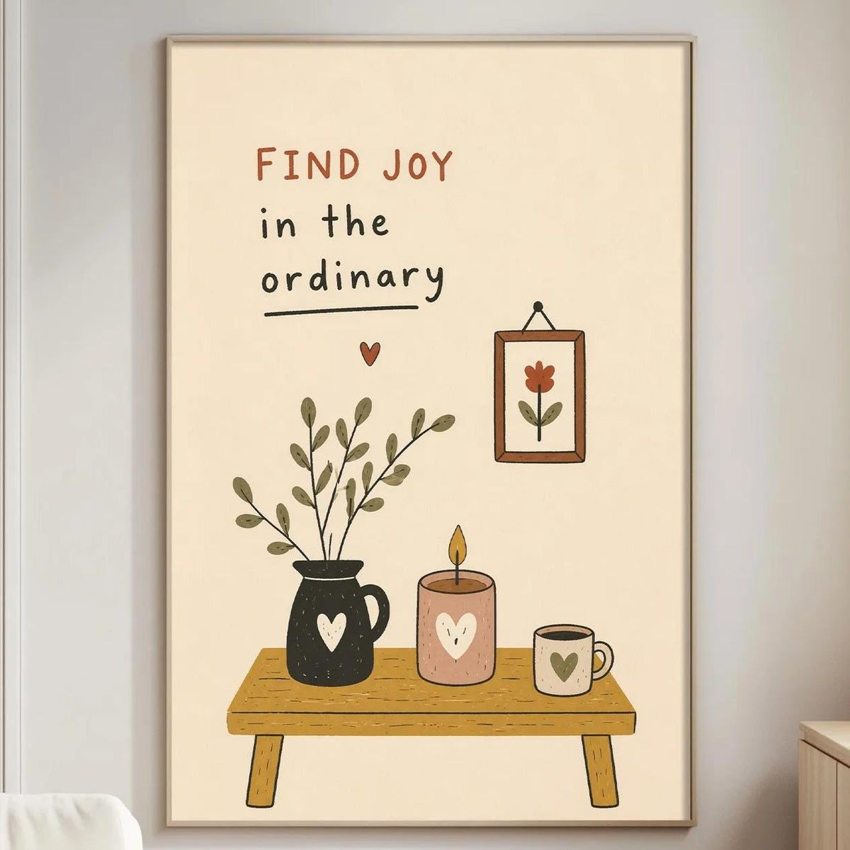 a living room with a framed poster on the wall that reads "Find joy in the ordinary" and includes illustrations of a vase with flowers, a candle, and a coffee mug.