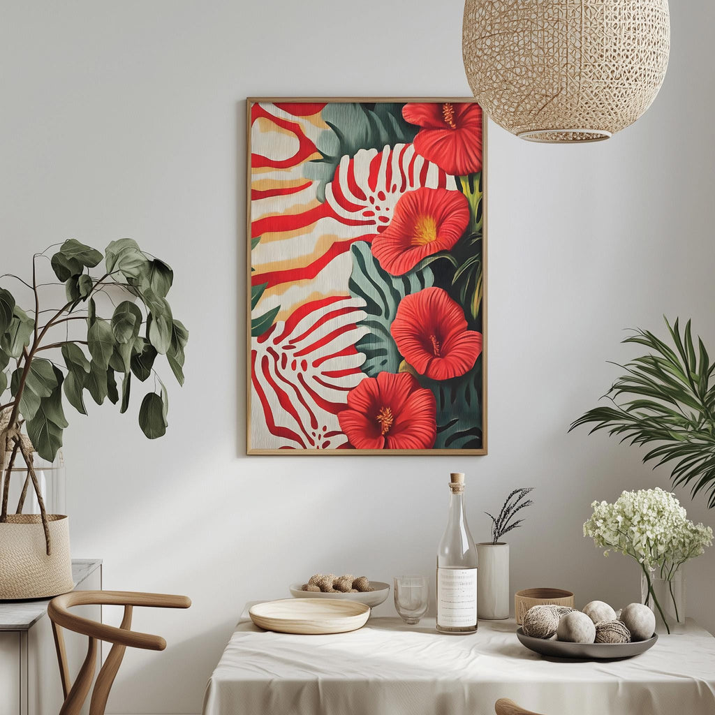 a dining table with a white tablecloth, a vase of white flowers, a bottle, and a bowl of fruit. Above the table, there is a framed painting of red and green tropical flowers hanging on the wall.