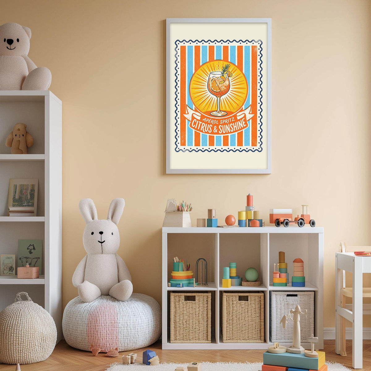A child's bedroom with a white bookshelf, a stuffed rabbit, and a toy train. Above the bookshelf is a framed poster with an illustration of a cocktail glass and the text "Citrus & Sunshine".