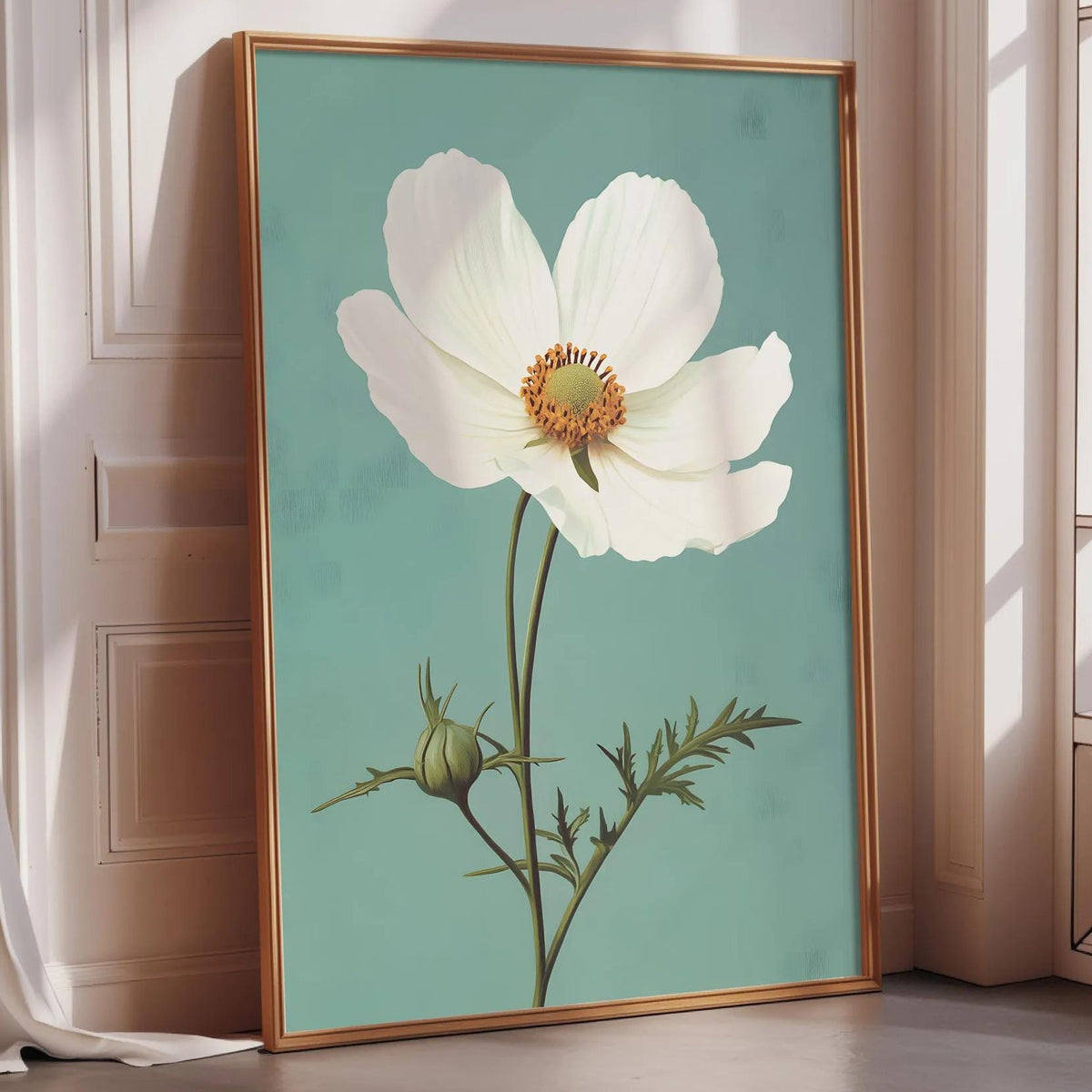 A framed painting of a white flower with a green stem and leaves is displayed on a wall in a room with a window.