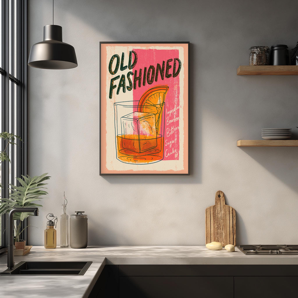 a framed poster of a cocktail glass with an orange slice, hanging on a wall above a kitchen counter.