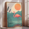 A framed illustration of a pink flamingo standing in a body of water, with a large orange sun in the background.