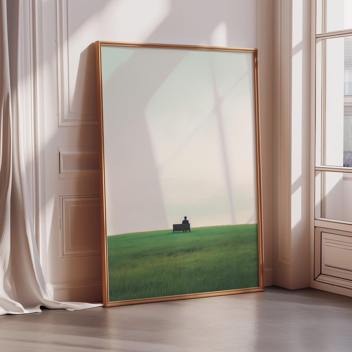 a large, framed picture of a green field with a small building in the distance, set against a cloudy sky.