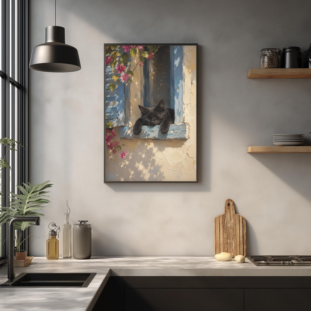 a black cat resting on a window sill, with a framed painting of the cat hanging on the wall above a kitchen counter.