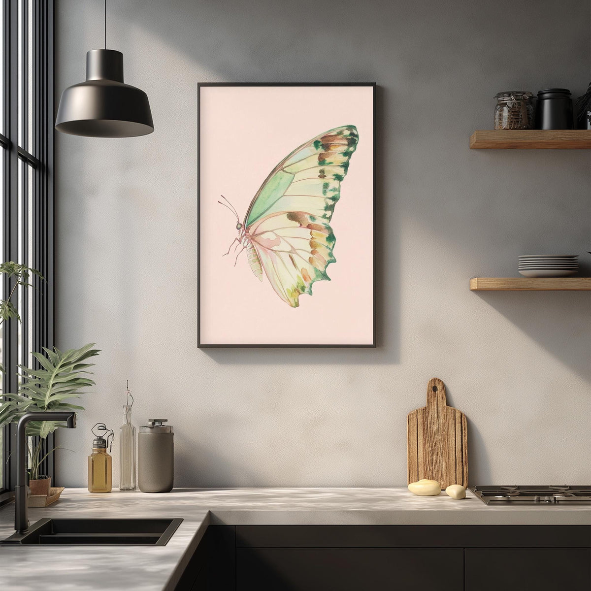 a kitchen counter with a framed picture of a butterfly hanging on the wall above it. The kitchen counter also has various kitchen items such as a cutting board, a knife, and a bottle.