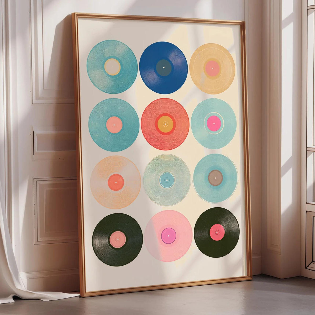 A framed collage of colorful vinyl records is displayed on a wall in a room with sunlight streaming in through a window.