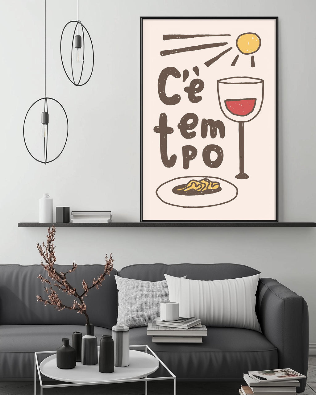 a modern living room with a gray sofa, a coffee table, and a framed poster on the wall. The poster has a whimsical illustration of a wine glass, a plate of food, and a sun, accompanied by the text "Ce tem po".
